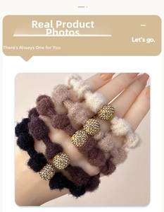 Detail of plush knitted hair scrunchies with sparkling rhinestone gold ball ornaments