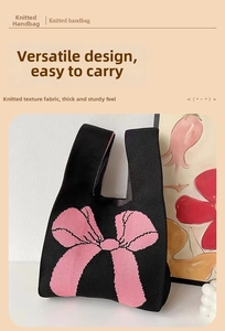 Close-up of black knitted tote bag featuring a pink bow pattern and thick texture