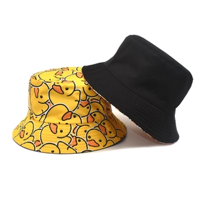 Reversible bucket hat with yellow cartoon duck print and classic black solid color design