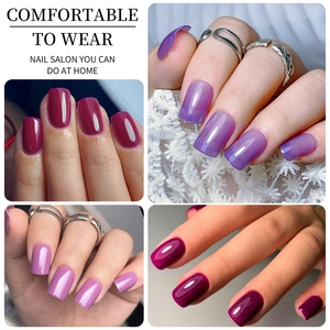 Close-up of matte press-on nails in red, purple gradient, and pink colors for home manicure