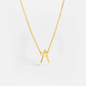Close-up of golden S925 sterling silver letter A necklace with a sparkling round diamond