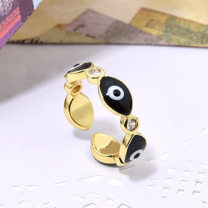 Adjustable gold evil eye ring with black enamel and sparkling zircon accents