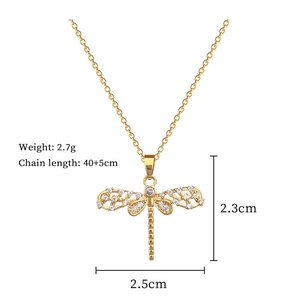 Detail view of gold dragonfly pendant with dimensions 2.3x2.5cm and chain specs