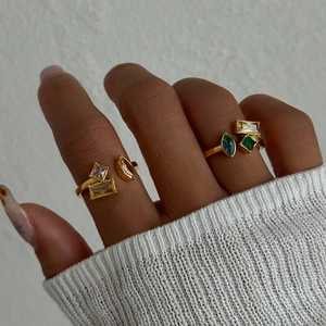 Close-up of stacked 18k gold plated rings with colorful geometric zircon gemstones