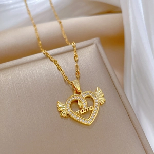 Golden heart angel wings necklace with mama inscription on beige jewelry box