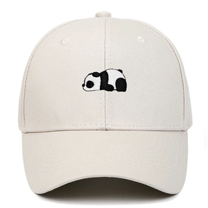 Close-up of a panda embroidery detail on a beige cotton baseball cap with high-quality stitching