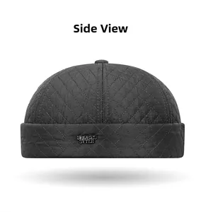 Side view of dark gray quilted docker hat with fleece lining and metal sports label