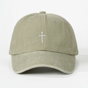 Close-up of cross embroidery and washed cotton texture on khaki baseball cap