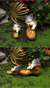 Detail of miniature resin cats sleeping in yellow work boots for fairy garden decor