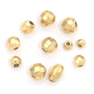 Faceted vacuum-plated gold stainless steel spacer beads for DIY jewelry making on white background