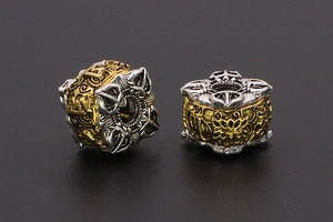 Macro detail of retro ethnic two-tone beads with intricate embossed carvings