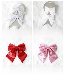 Detailed view of sparkly Christmas bows with sequins and glitter in silver and red