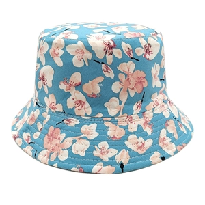 Detail of light blue bucket hat with floral print and reinforced stitching on the brim