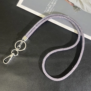 Macro shot of purple rhinestone phone lanyard with shiny silver metal lobster clasp