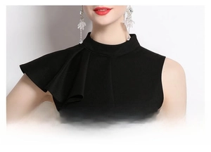 Detail of the stand collar and ruffle trim on this elegant black sleeveless top