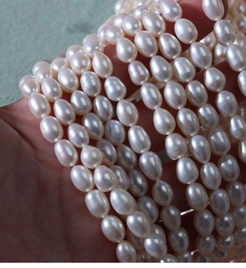 Detail showing high luster 5-6mm natural freshwater rice pearls on a strand