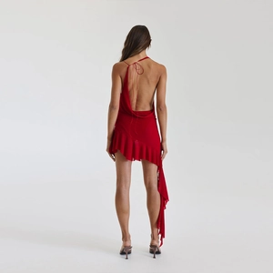 Detail of red backless dress with criss-cross tie straps and ruffled asymmetric hemline