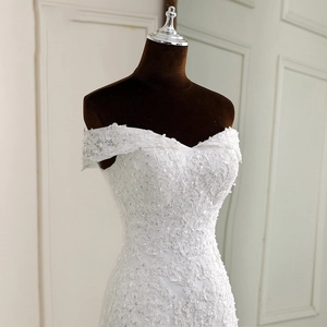 Elegant off-shoulder mermaid wedding dress in white lace with sequin embroidery details