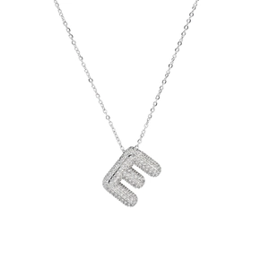 Macro shot of silver letter E pendant featuring sparkling zircon micro-pave setting