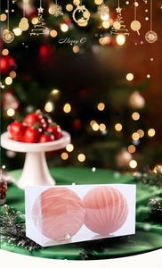 Close-up of pink flocked Christmas ball ornaments with spiral texture in gift box