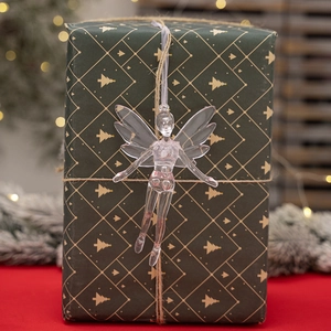 Clear acrylic Christmas angel ornament with wings hanging on festive background