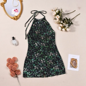 Flat lay of halter romper with green stone print surrounded by aesthetic lifestyle props