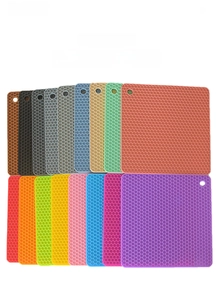 Flat lay of square honeycomb silicone placemats in 15 colors with hanging holes
