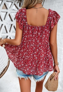 Back view of floral ruffle sleeve tiered doll top with red flower pattern
