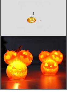 Close-up of three stacked pumpkin lanterns with interior lighting and twine hanger