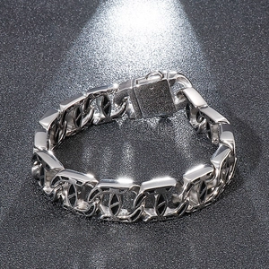 Close-up of polished silver punk stainless steel chain bracelet with square clasp