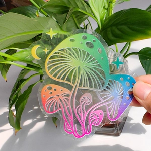 Close-up of mushroom suncatcher window sticker with rainbow prism lines and patterns
