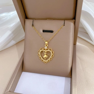Golden heart necklace with ballet dancer pendant and rhinestones in a luxury jewelry box
