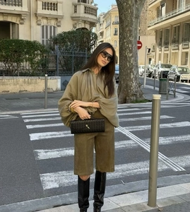 Street style view of olive green oversized shirt and matching wide leg bermuda shorts