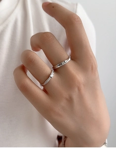 Detail of adjustable S925 silver Mobius rings set on hand showing sparkling zircon stones