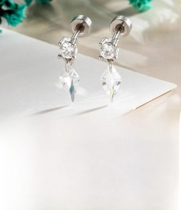 Detail of silver titanium steel cartilage stud earring with rhombus zircon pendant