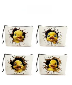 Detail view of four canvas makeup bags featuring 3D cartoon duckling prints and zippers