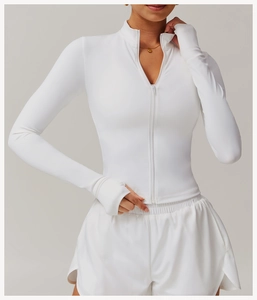 Close-up of white slim fit yoga jacket featuring thumbholes and stand collar detail