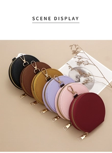 Various colored round coin purses with litchi grain texture and gold zipper hardware
