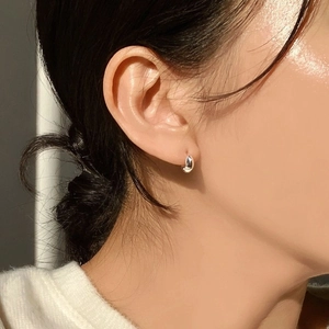 Minimalist 925 sterling silver oval hoop earring on model showing elegant profile view