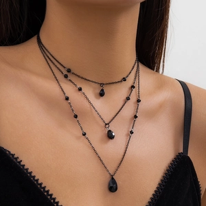 Gothic tiered black necklace featuring layered chains and a teardrop crystal pendant