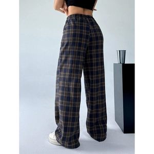 Detail of high-waist elastic waistband and vintage navy plaid pattern on wide-leg pants