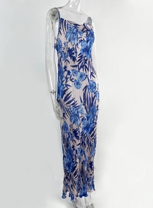 Detail of dark blue floral print pleated dress featuring cowl neck and thin straps
