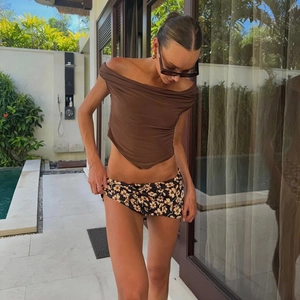 Close-up of lightweight brown floral print wrap skirt with high waist for summer wear
