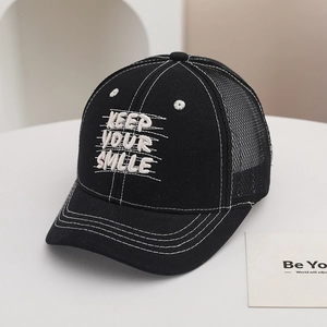 Detail of black trucker hat with KEEP YOUR SMILE embroidery and breathable mesh back