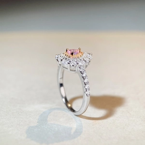 Detailed view of pink heart diamond ring with double-layered halo and diamond-set band