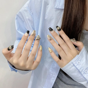 Handmade press-on nails with black marble texture, gold foil and 3D zircon accents