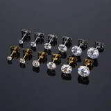 Macro shot of 6 pairs silver and gold stainless steel stud earrings with round zircons