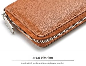 Close-up of the neat stitching and brown lychee grain leather on a zip wallet