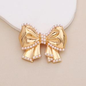 Detail of golden bow charm with pearl accents for shoes and phone case DIY accessories