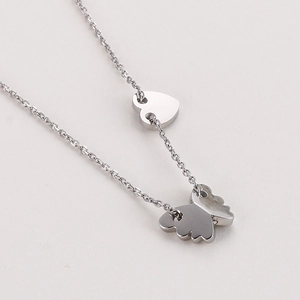 Detail shot of silver butterfly and heart pendants on a stainless steel chain